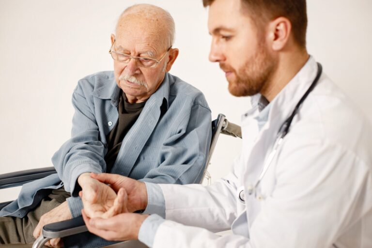 Doctor taking Pulse of Elderly Man